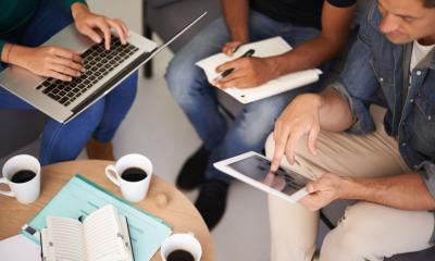 A group of small business employees using new tech