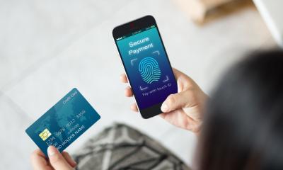 A woman making a secure payment on her mobile phone