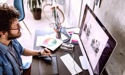 A man is designing posters to sell online