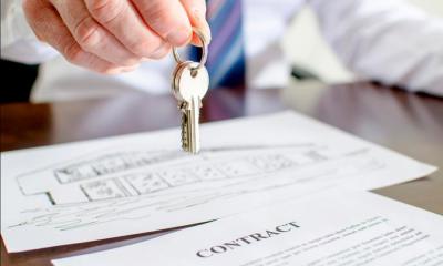 Hand holding keys over property licence agreement
