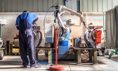 Robot and worker in a factory