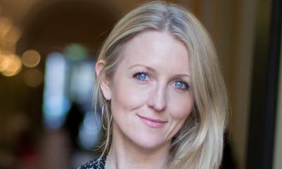 Woman with blonde hair blue eyes looking at the camera while smiling
