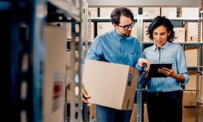 Two small business owners check a dispatch list for export