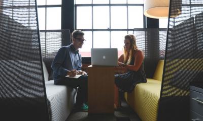 Two people talking about how to spend less on and get more out of your business meetings