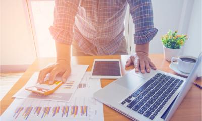 Businessman looking at turnover figures to work out whether he needs a business loan.