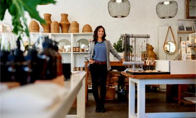 A smiling female entrepreneur in her high street shop