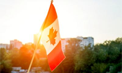 Canadian flag viewed through the window of a business meeting