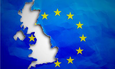 Piece in form of UK borders torn out from the flag of the European Union Piece in form of UK borders torn out from the flag of the European Union