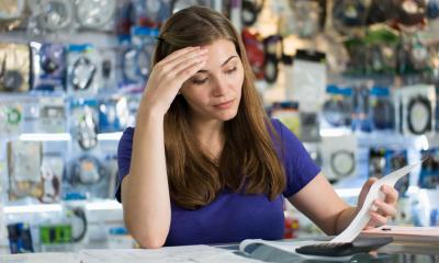 A concerned businesswoman worries she won't be able to pay her bills