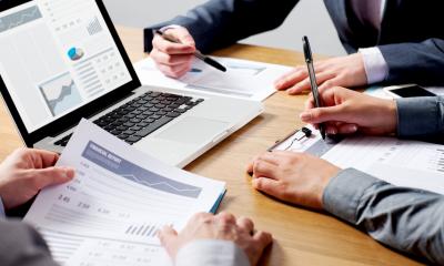 Choose and use accountants and lawyers Businesspeople looking through paperwork with professional advisers