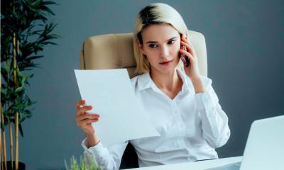 A young woman discusses a finance application on the phone