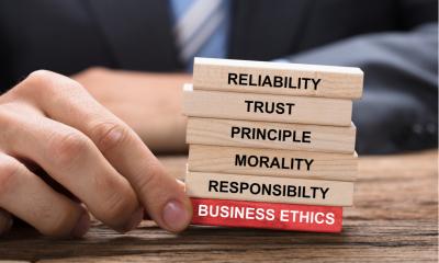Man in a suit holding wooden blocks that make up a companies reputation