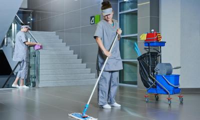 Contract cleaning business mopping the floors in a big office block