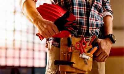 A self employed workman gathers his tools