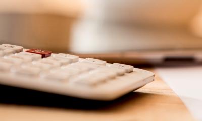 A calculator is being used to calculate customer credit