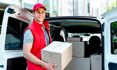 A delivery driver loads his van