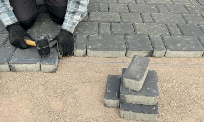 Sorting grey patio bricks for a driveway