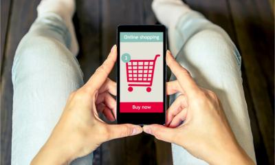 A woman is shopping online using her mobile phone