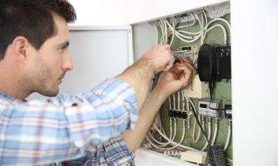 Electrician fixing a power box