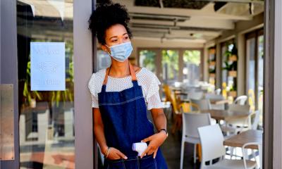 A small business owner waits for her staff to return