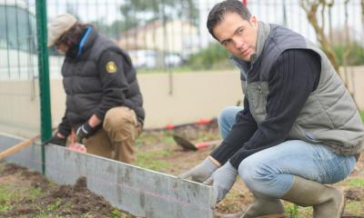 Two men starting to build a fence in the winter