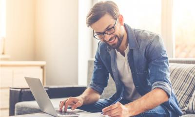 An attractive businessman is planning his online business using a range of online tools