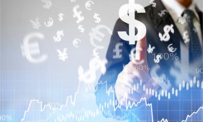 Businessman with financial symbols for different international currencies coming from hand