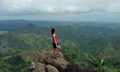 Girl in red top at the top of summit in Ella, Sri Lanka