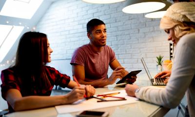 Group of people sat around a table thinking of ideas of how to grow a business