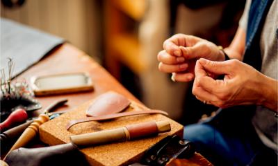 A leatherworker makes products to sell online