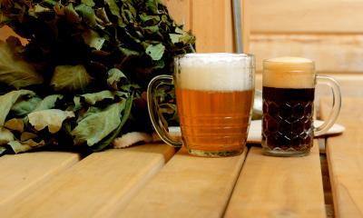 Two different glasses containing Bath Ales beers on a wooden table