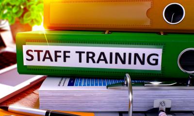 Staff training folder on desk Identifying training needs - checklist