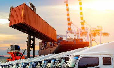 International trade logistics Shipping container and delivery lorries at international logistics hub