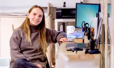 A young entrepreneur sets up her first business in a home office.