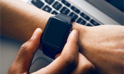 A man uses his smartwatch at work
