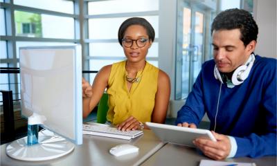 A man and woman work on their contractor contracts ready for IR35 rules