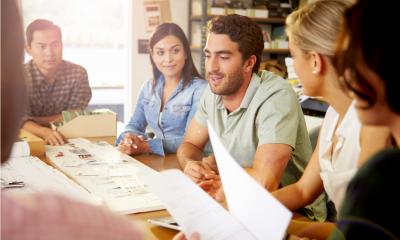 A group of people sitting around a meeting table discussing how to rapidly scale a business