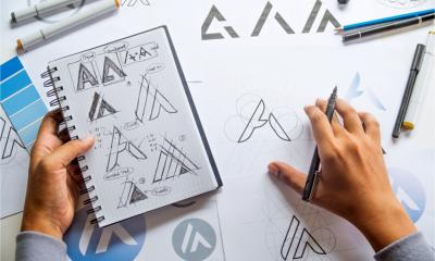 A man sketches out some ideas for a company logo