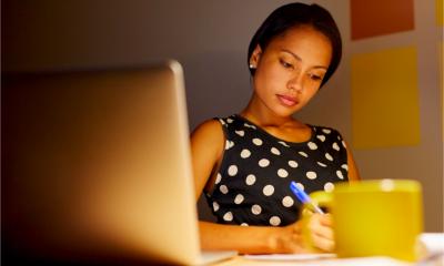 A female employee works late into the night from home