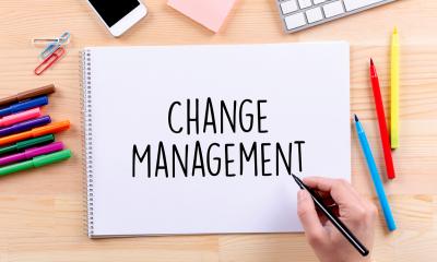 Managing change - checklist Change management written on paper in black pen