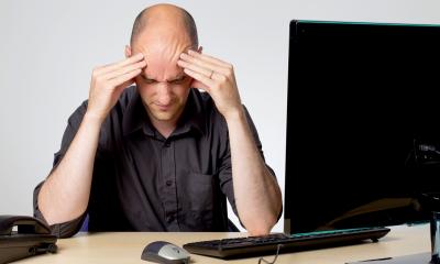 Managing your stress - checklist Stressed man sitting in his desk