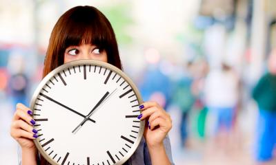 Managing your time - checklist Lady holding big clock