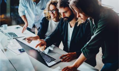 A marketing team review the data from their market intelligence platform