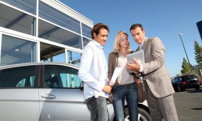 Car salesman selling a Vauxhall Astra to a couple