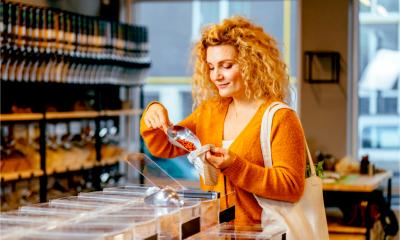A woman purchases produce in a zero packaging shop