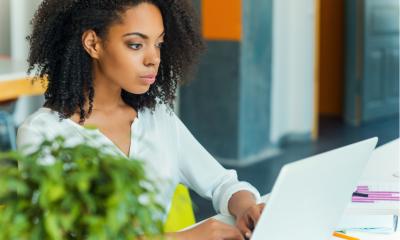 Young female business women learning of new insolvency rules on her laptop