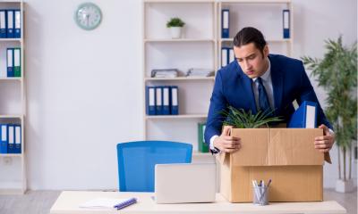 Employee putting all of his work belongings into a cardboard box