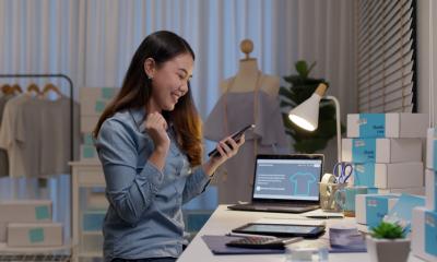A businesswoman receives a payment via her payment processing provider