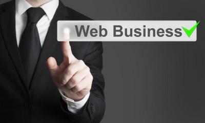 Man in black suit pointing to piece of text in front of him