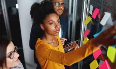 Small business team creating a marketing plan using post-it notes